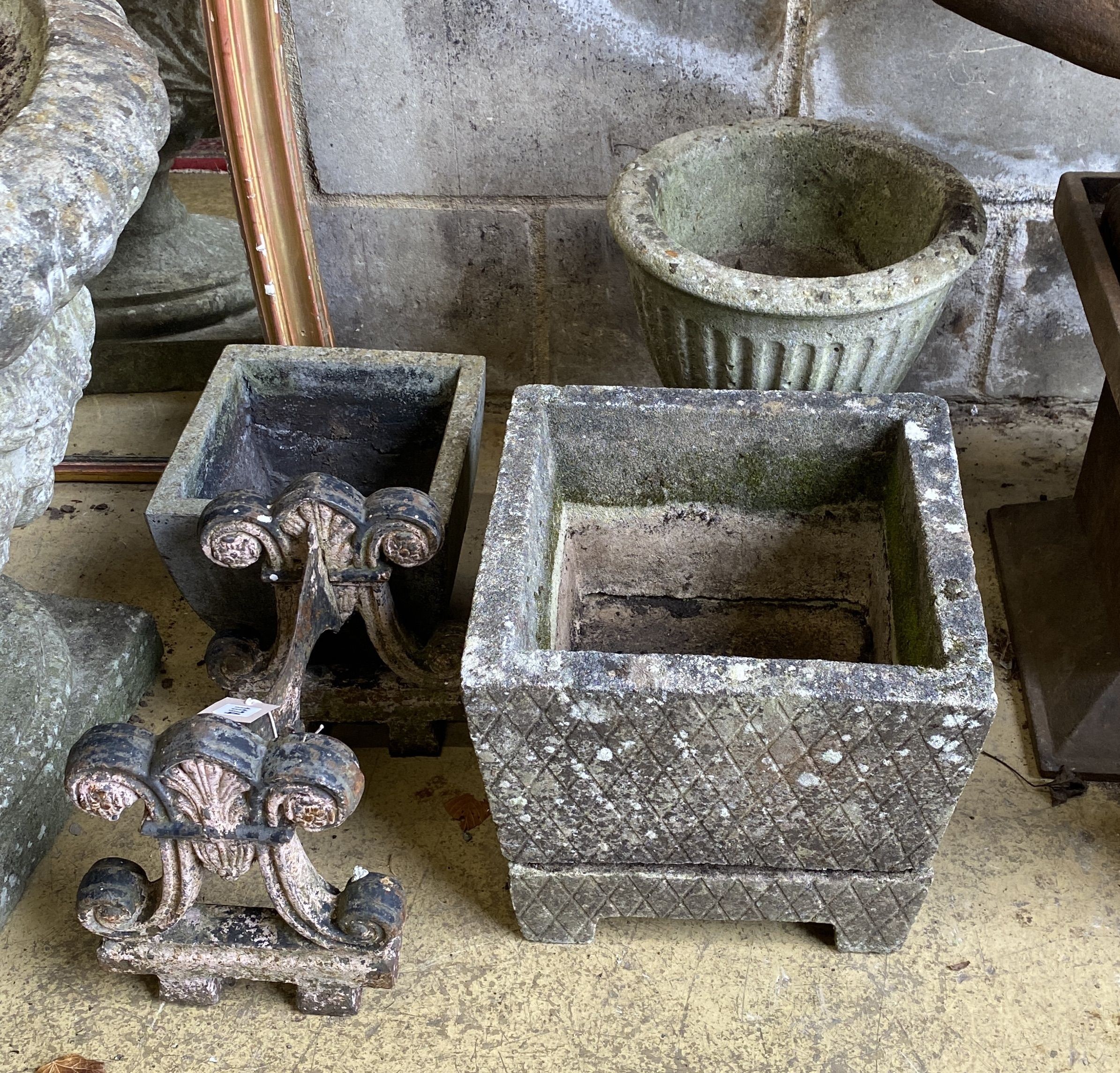 A Victorian cast iron boot scraper and three reconstituted stone garden urns, largest width 32cm, height 28cm
